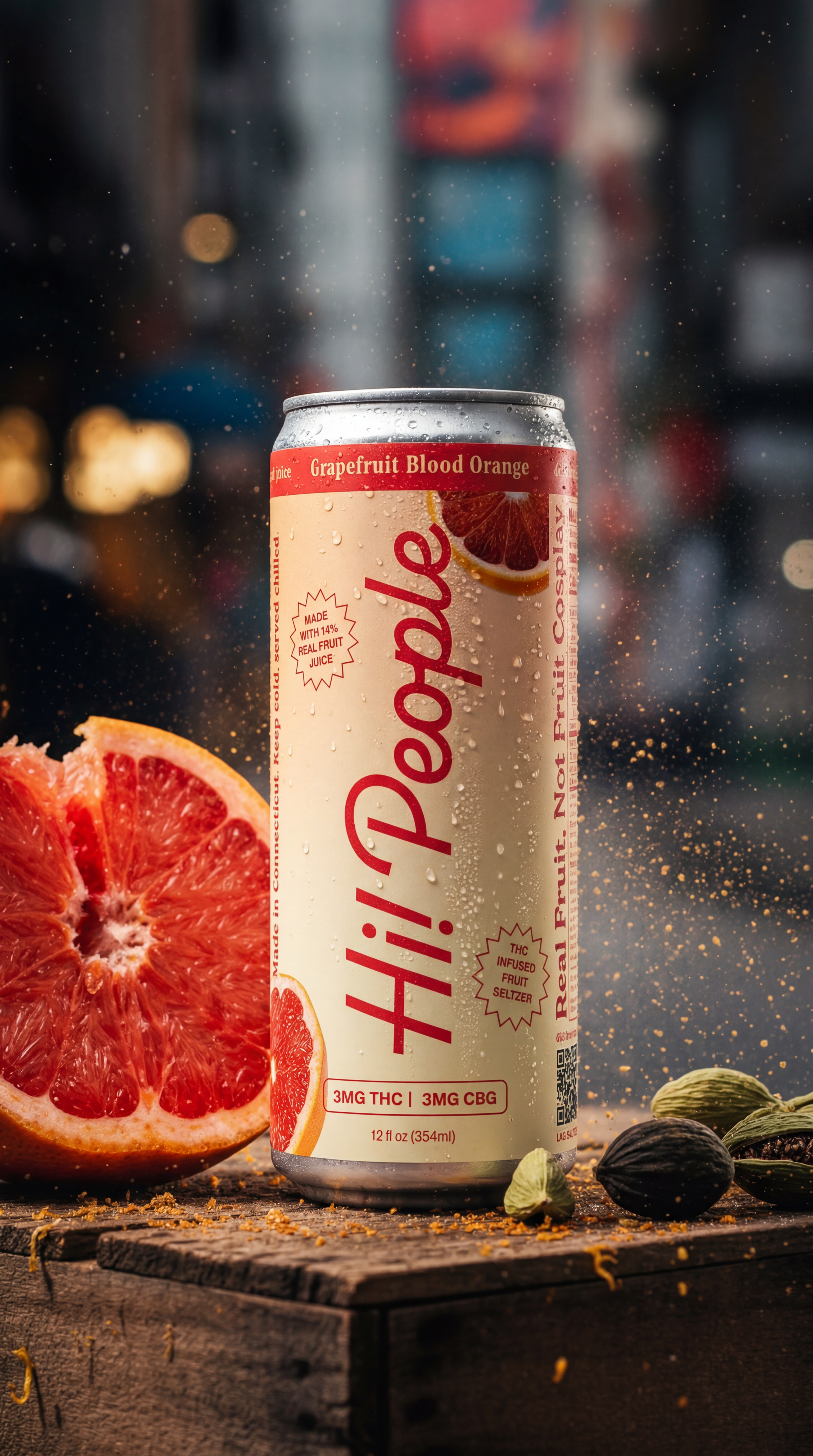 Hi! People Grapefruit Blood Orange hemp seltzer can on a wooden crate with halved grapefruit and cardamom pods in an urban alley