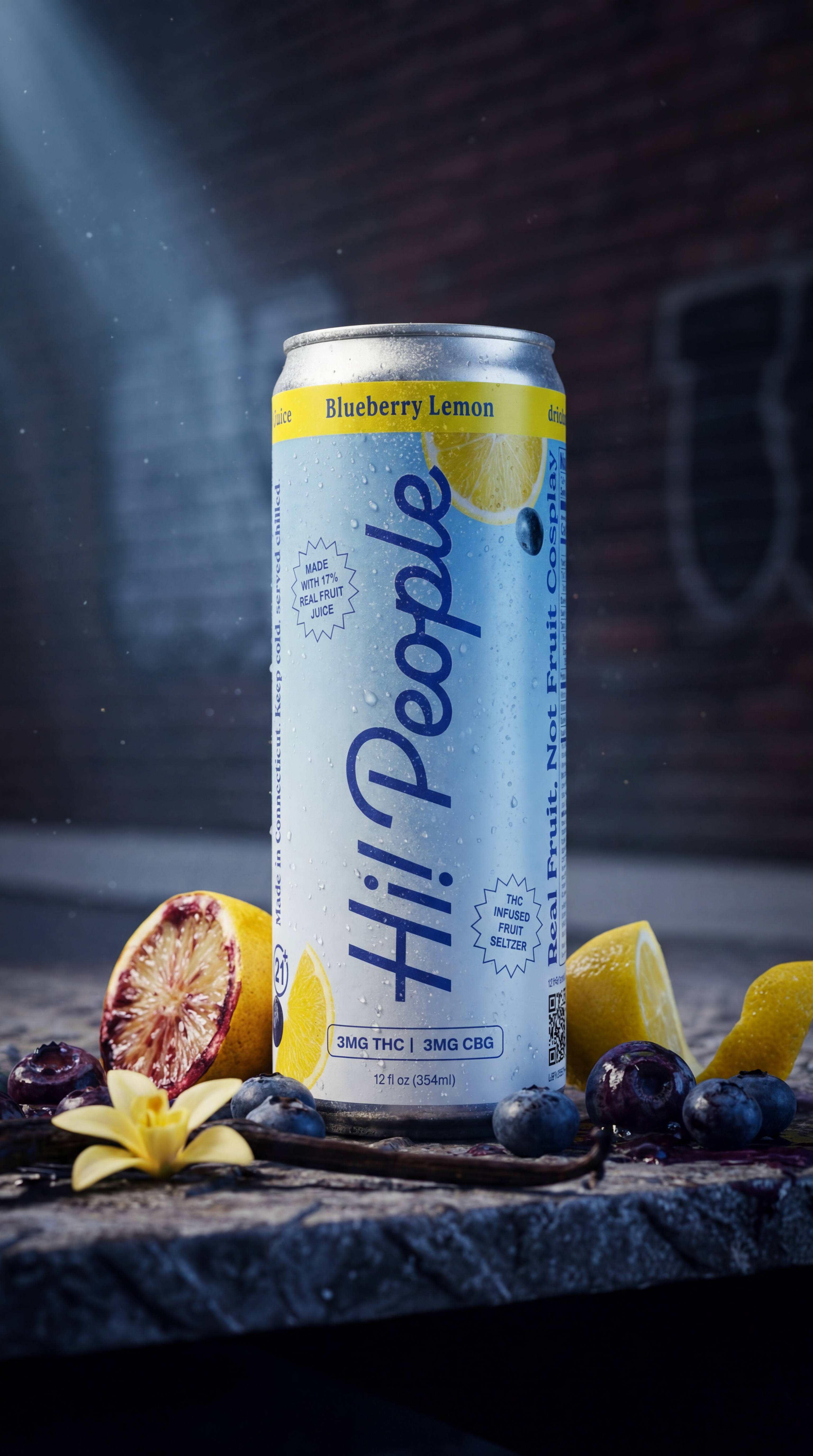 Hi! People Blueberry Lemon hemp seltzer can on concrete with fresh blueberries, lemon peel, and vanilla against a brick wall